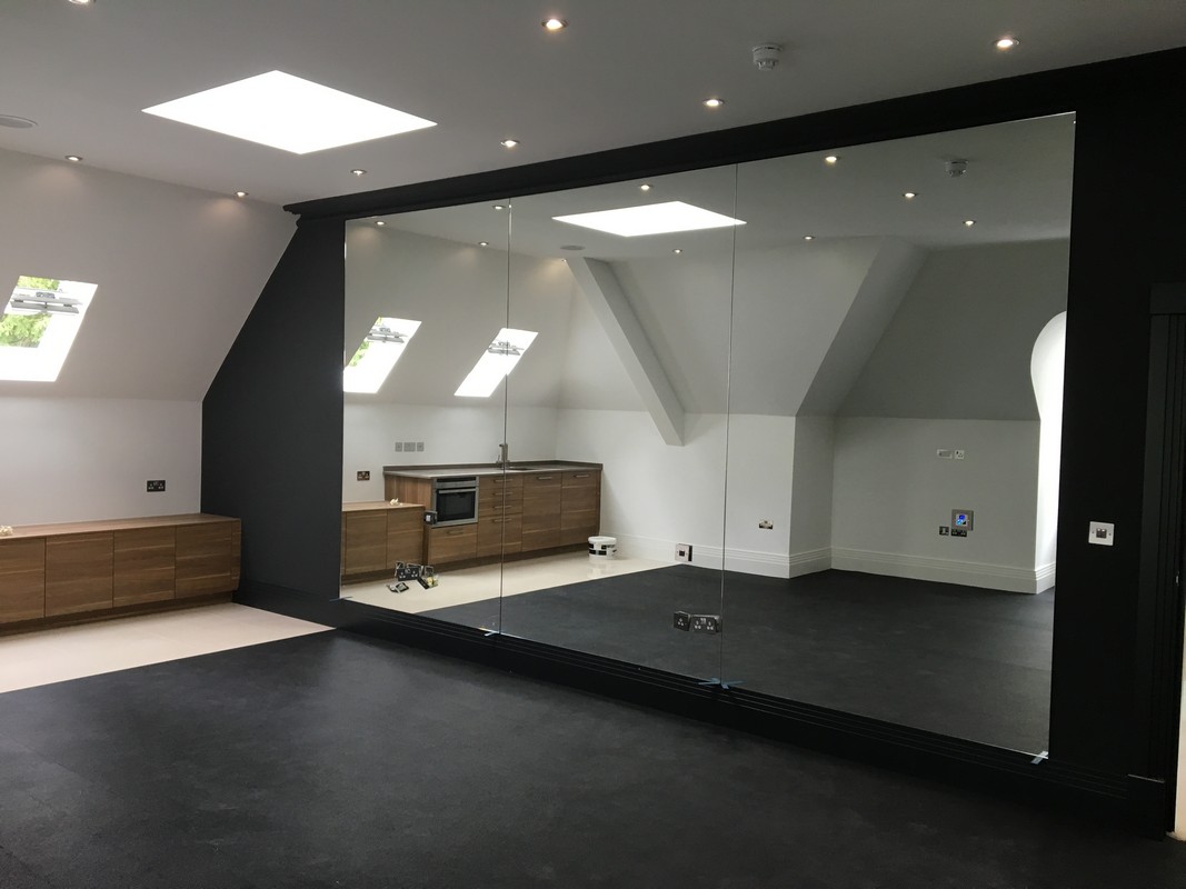 Frameless glass wall dividing loft conversion in Isleworth
